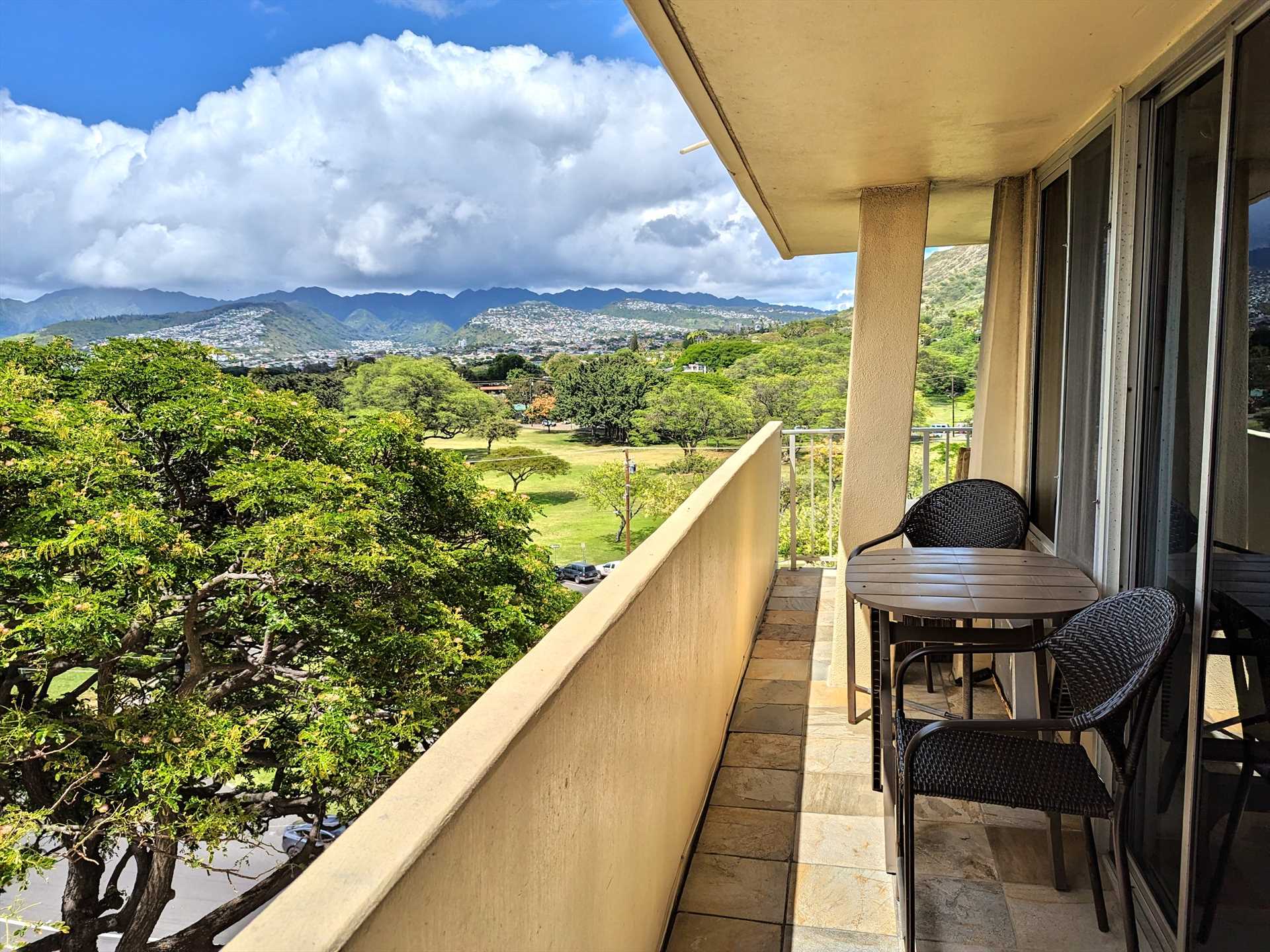 A large lanai with a view of the ocean and the park.