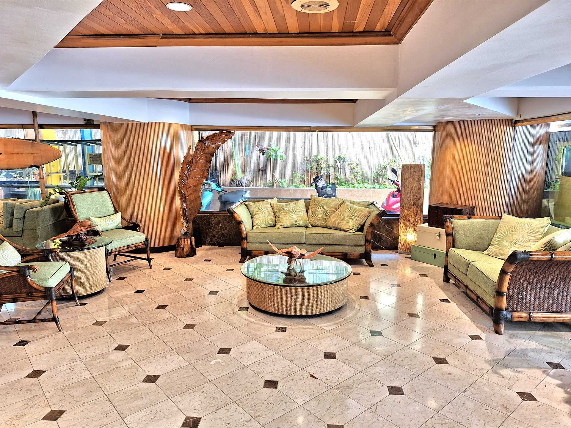 The lobby is elegant, spacious and inviting with a tropical 